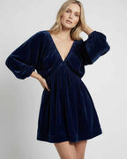 Celeste Mini Dress in navy velvet, featuring long sleeves and a V neck silhouette by Lauven, offering chic elegance.