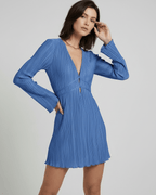 Celeste Mini Dress by Lauven, pleated long sleeve in soft blue, featuring deep V-neckline and flared mini skirt.