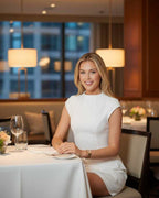 Celeste Mini Dress worn in a chic restaurant setting, highlighting its sleek design and refined elegance by Lauven.