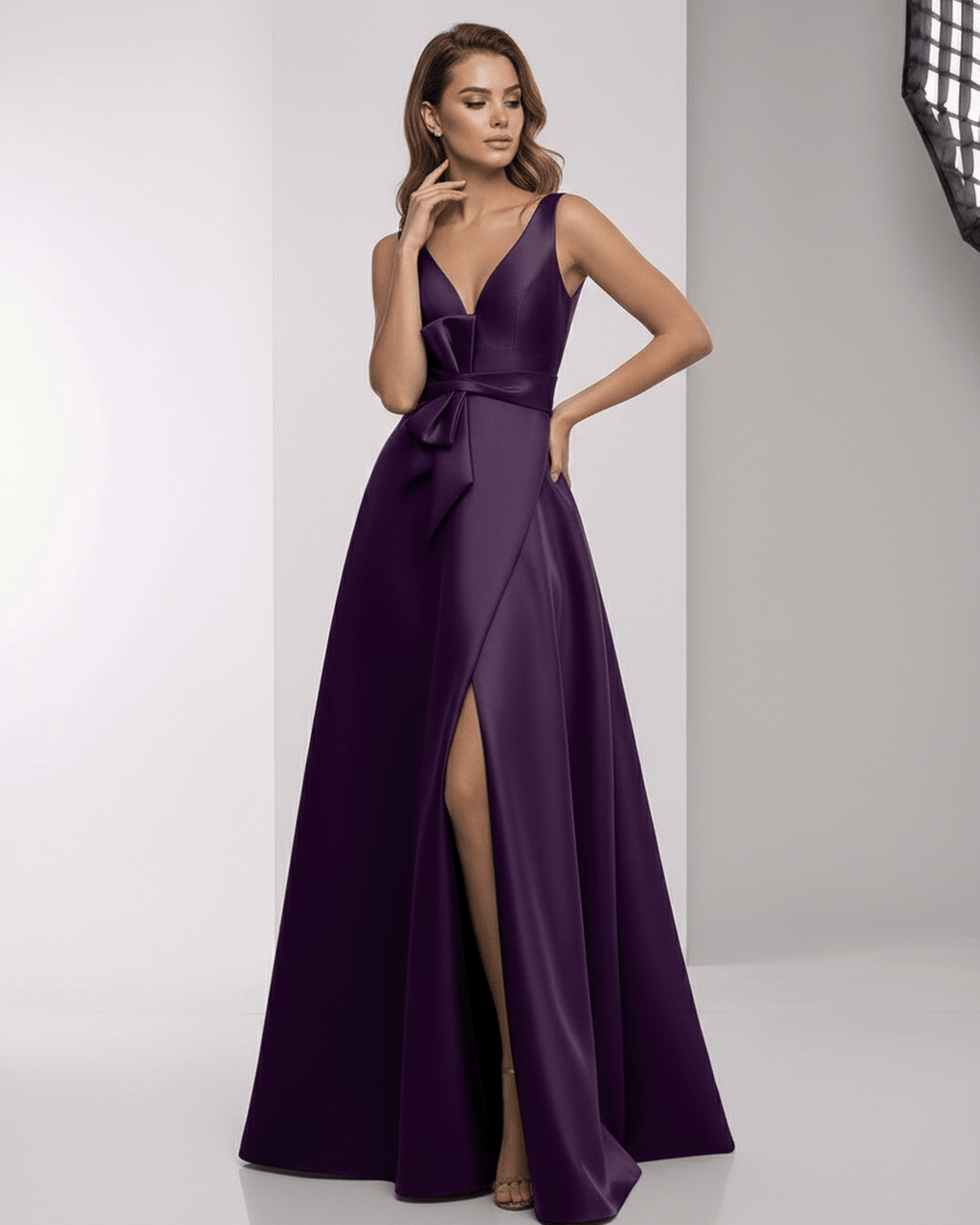 Celestia Maxi Dress in deep purple satin, featuring a wrap slit, bow waist, and elegant A-line silhouette by Lauven.