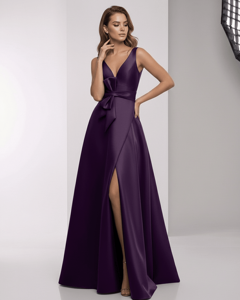 Celestia Maxi Dress in deep purple satin, featuring a wrap slit, bow waist, and elegant A-line silhouette by Lauven.