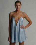 Celestial Mini Dress by Lauven in icy blue satin, featuring a hollow V-neckline and beaded spaghetti straps.