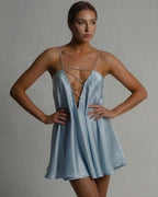 Lauven Celestial Mini Dress in icy blue satin with beaded spaghetti straps and flared A-line silhouette.