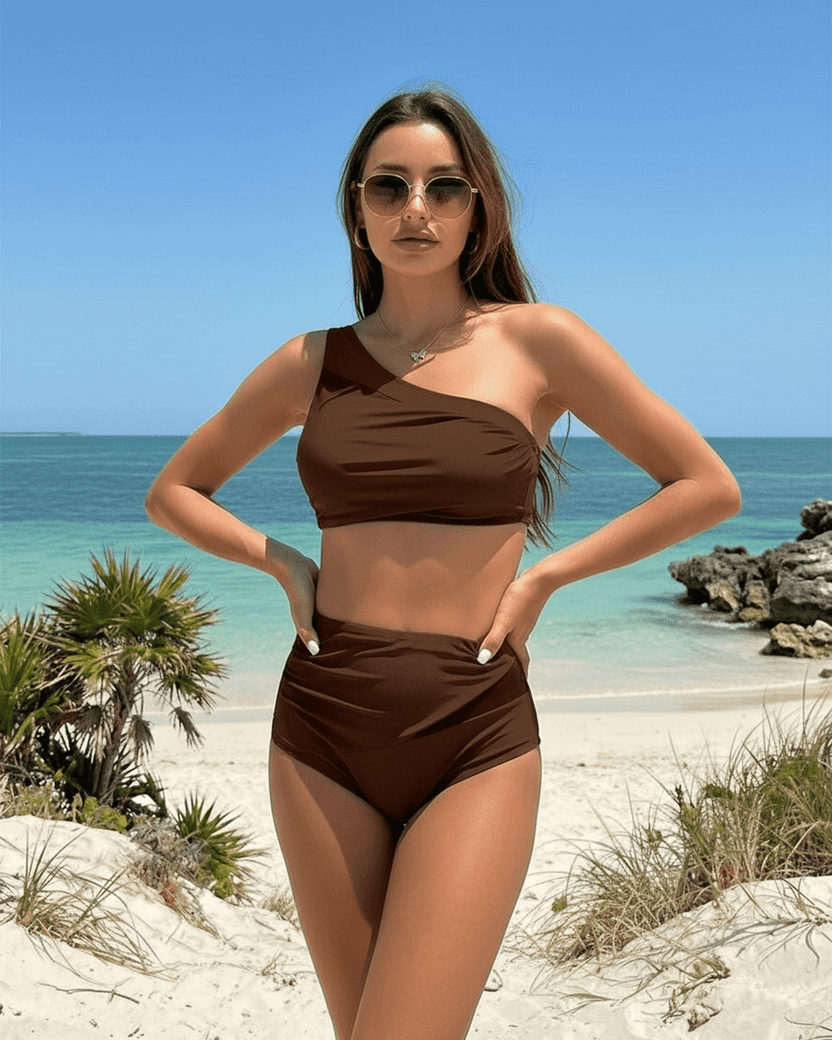 Lauven Chestnut Two-Piece Swimsuit featuring asymmetric design and underwire support on a beach.