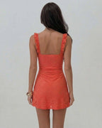 Back view of a model wearing the Lauven Coral Mini Dress with elegant lace detailing.