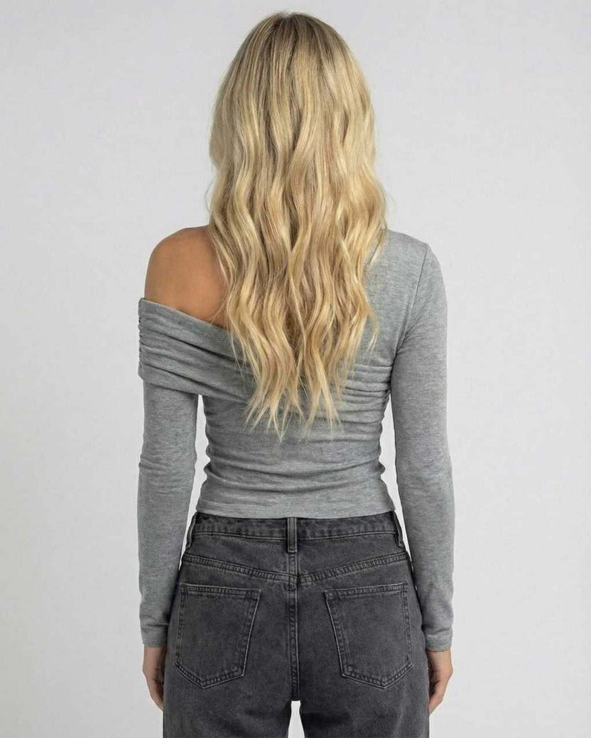 Back view of woman wearing Elara Long Sleeve off-the-shoulder top by Lauven in gray.