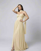 Elara Maxi Dress - Elegant beige strapless dress with choker scarf, showcasing graceful movement, by Lauven.