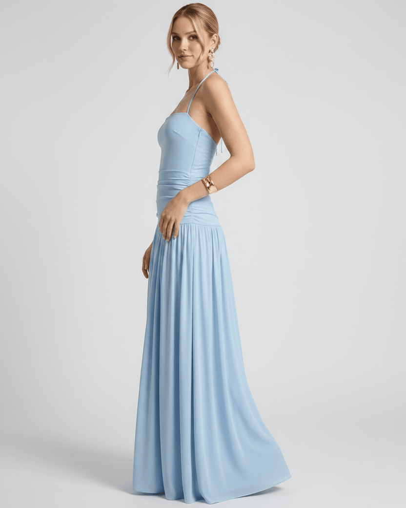 Elara Maxi Dress in light blue, featuring a halter neck, ruched waist, and flowing maxi length by Lauven.