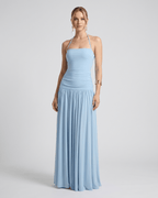 Elara Maxi Dress in soft blue, featuring stretch jersey, halter neck, and flowing full-length skirt by Lauven.