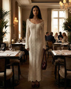 Elara Maxi Dress by Lauven featuring a ribbed V-neck and long flare sleeves, showcased in an elegant dining setting.