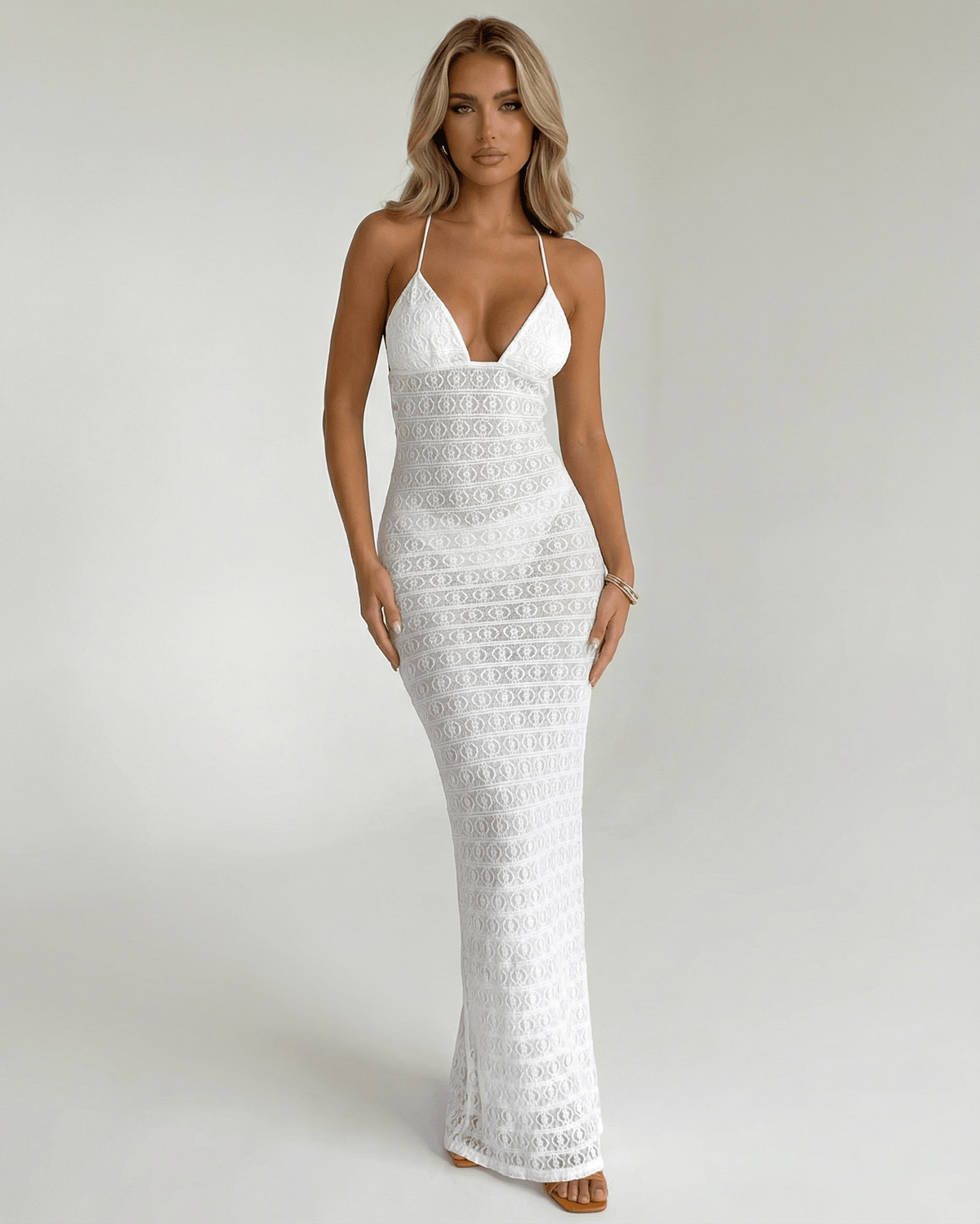 Elara Maxi Dress by Lauven: Elegant white lace V-neck halter dress featuring a sleek silhouette and delicate design.