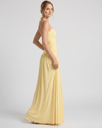 Elara Maxi Dress in soft yellow stretch jersey, featuring a halter neck and gently ruched waist for an elegant silhouette by Lauven.