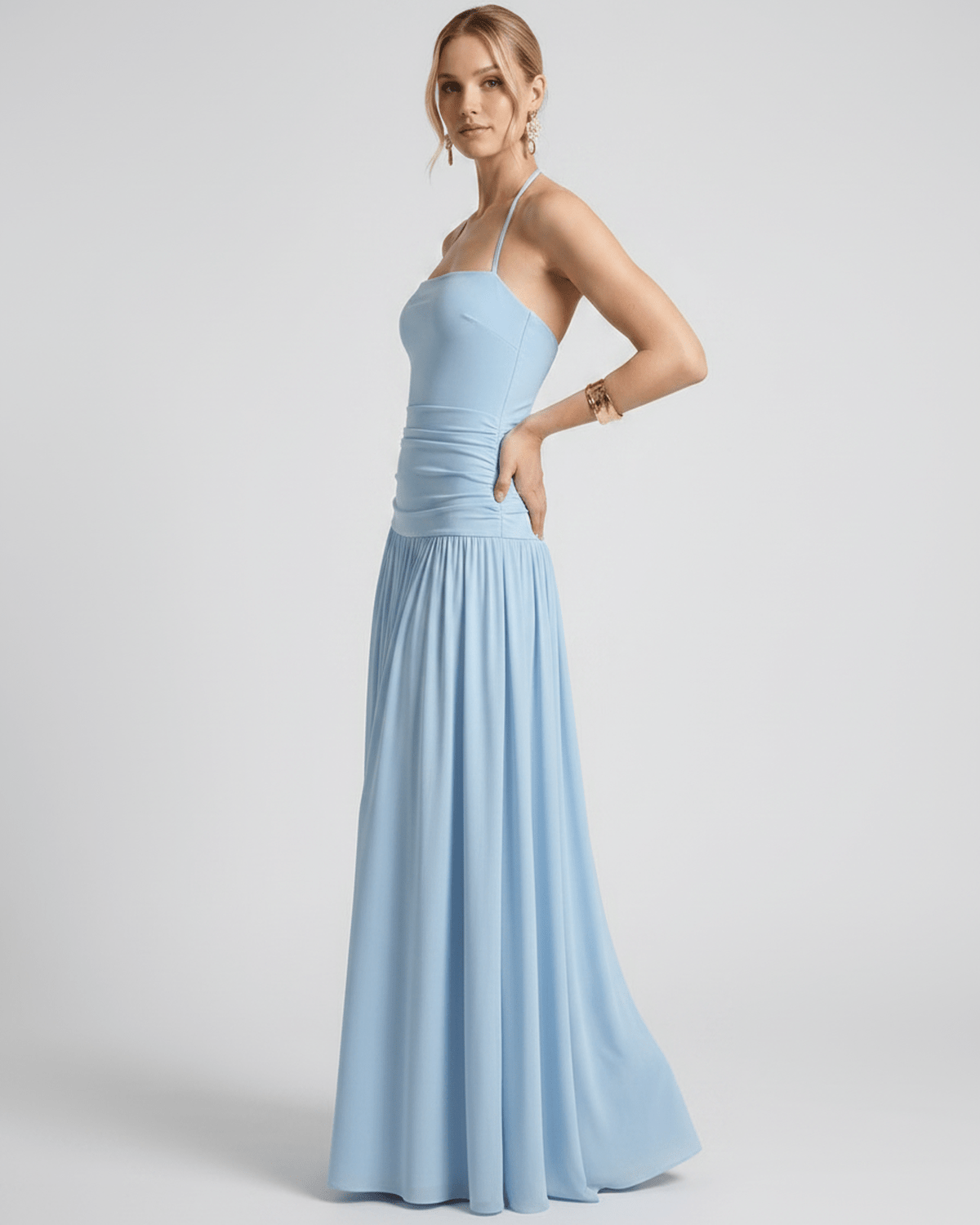 Elara Maxi Dress in light blue, featuring a halter neck, soft drape, and flowing skirt from Lauven.
