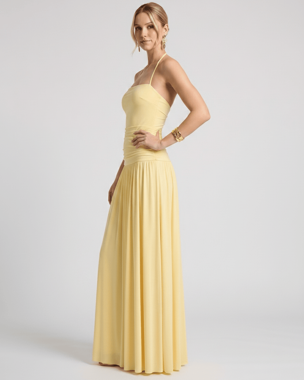 Elara Maxi Dress - Yellow halter neck gown in stretch jersey, featuring ruched waist and a fluid skirt from Lauven.