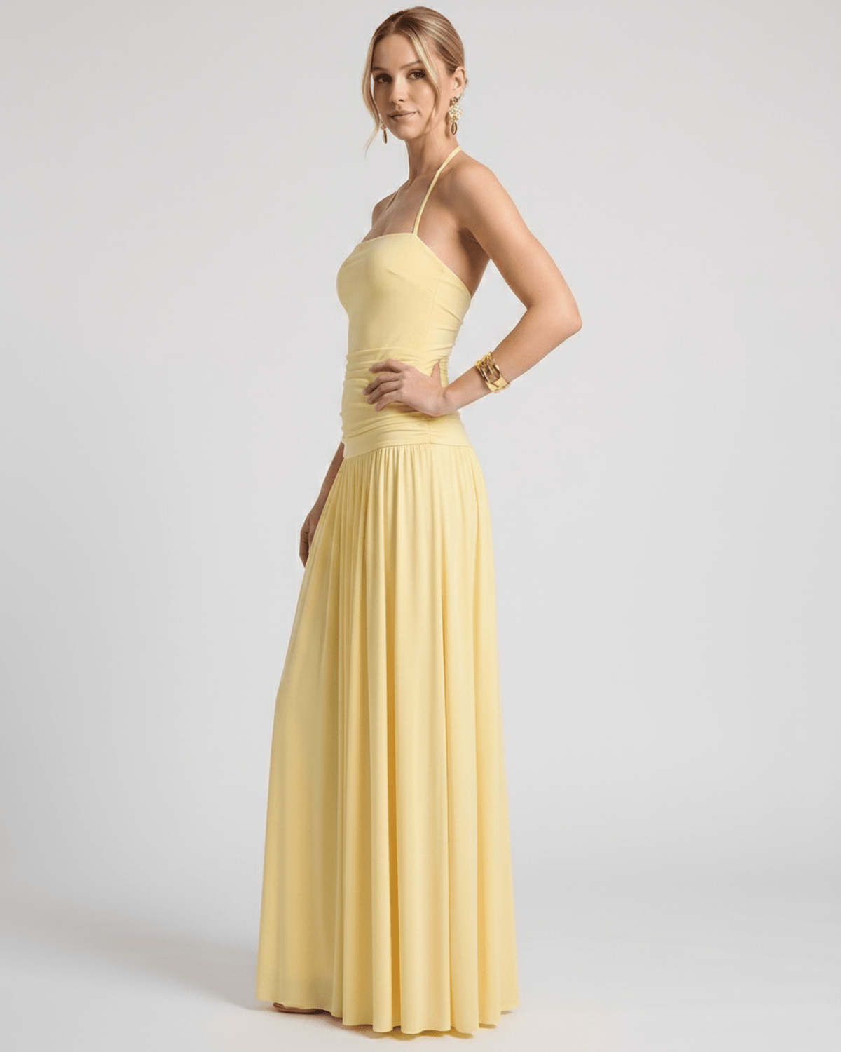 Elara Maxi Dress - Yellow halter neck gown in stretch jersey, featuring ruched waist and a fluid skirt from Lauven.