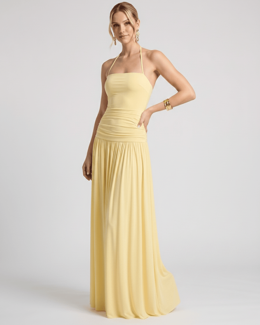 Elara Maxi Dress in soft yellow stretch jersey, featuring a halter neck and flowing skirt by Lauven.