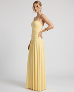 Elara Maxi Dress in yellow stretch jersey, halter neck design, featuring a ruched waist and flowing skirt for effortless elegance.