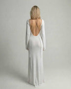 Elara Maxi Dress back view showcasing backless detail, flare sleeves, and elegant white A-line silhouette by Lauven.