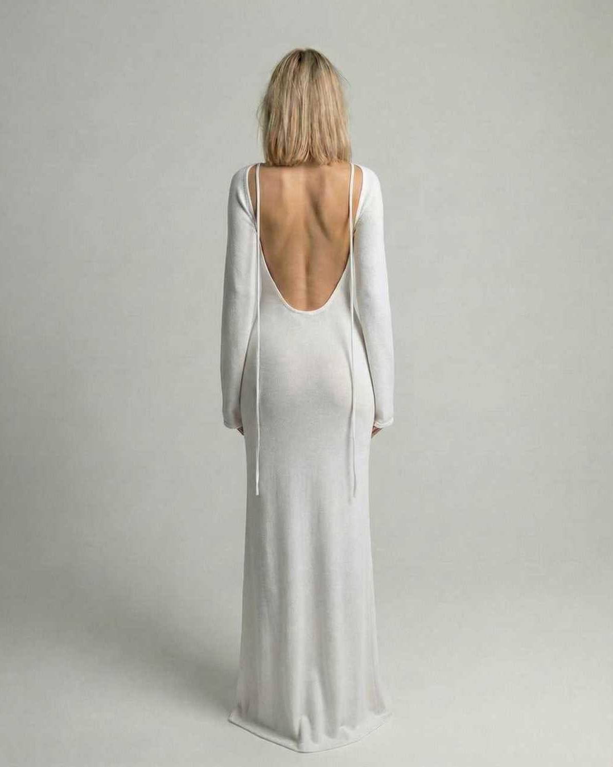 Elara Maxi Dress back view showcasing backless detail, flare sleeves, and elegant white A-line silhouette by Lauven.