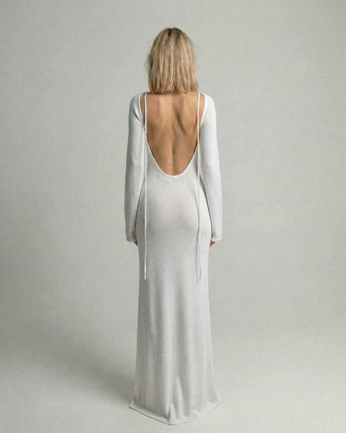 Elara Maxi Dress back view showcasing backless detail, flare sleeves, and elegant white A-line silhouette by Lauven.