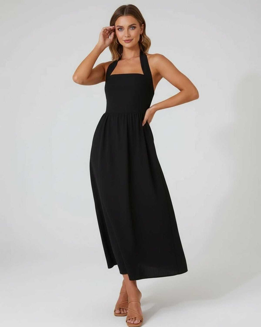 Elara Midi Dress, elegant black halter design, flowy A-line silhouette, showcasing effortless modern style by Lauven.