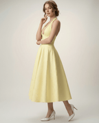 Elara Midi Dress in yellow, elegant halter A-line silhouette, showcasing sophistication by Lauven.