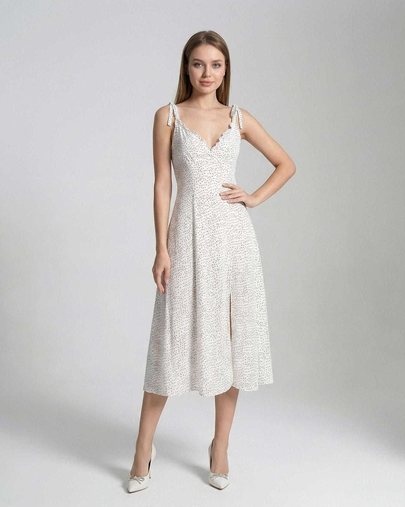 Elara Midi Dress by Lauven featuring an elegant A-line silhouette and polka dot detail on a model.