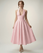 Elara Midi Dress in soft pink, featuring a halter neckline, A-line silhouette, and structured fit by Lauven.