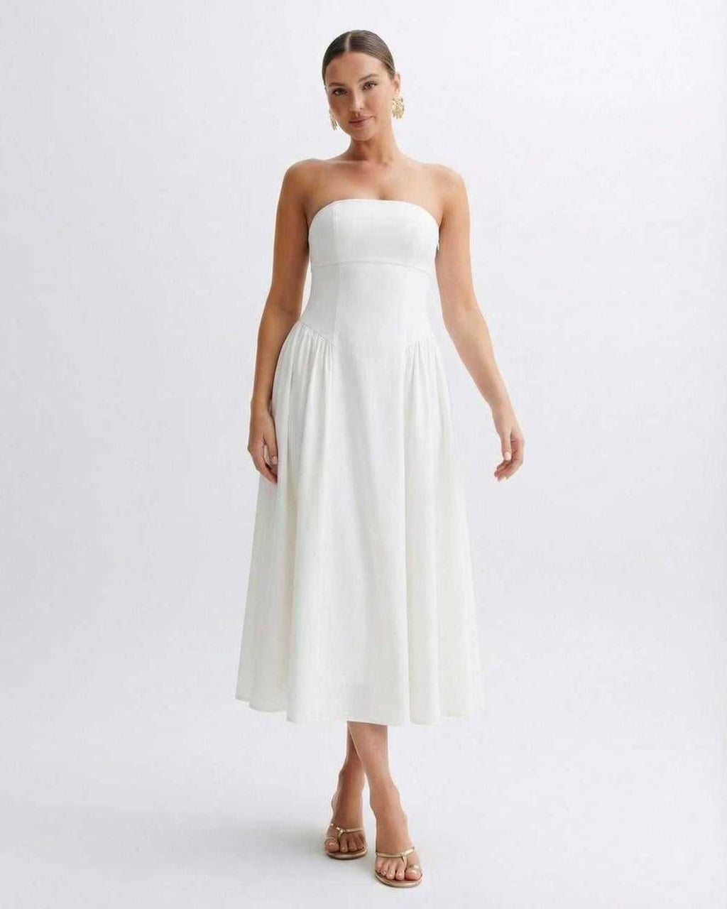 Elara Midi Dress by Lauven, a strapless white pleated dress with a clean bandeau neckline, capturing timeless elegance.