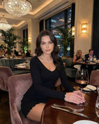 Elara Mini Dress by Lauven in Classic Black, V-Neck, Slim Fit, elegant office look in stylish restaurant setting.