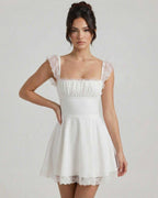 Elara Mini Dress by Lauven, featuring lace cap sleeves and a vintage A-line silhouette in soft white fabric.