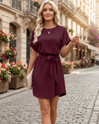 Elara Mini Dress in burgundy, featuring a relaxed fit, self-tie waist belt, and round neckline. By Lauven.
