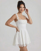 Elara Mini Dress by Lauven, white lace A-line mini dress with gathered bust and cap sleeves.