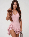 Elara Mini Dress by Lauven, pink ruffle hem halter neck dress, styled with a small dog.