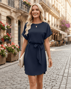 Elara Mini Dress in navy, smooth woven fabric, round neckline, self-tie waist, from Lauven brand, perfect for modern elegance.