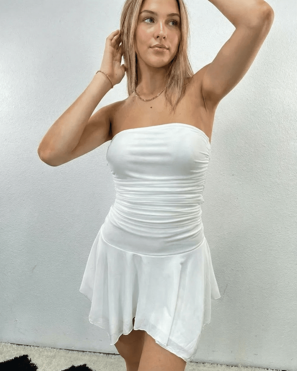 Elara Mini Dress by Lauven, strapless ruched mini dress with flowy hem in white color.