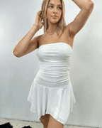 Elara Mini Dress by Lauven, strapless ruched mini dress with flowy hem in white color.