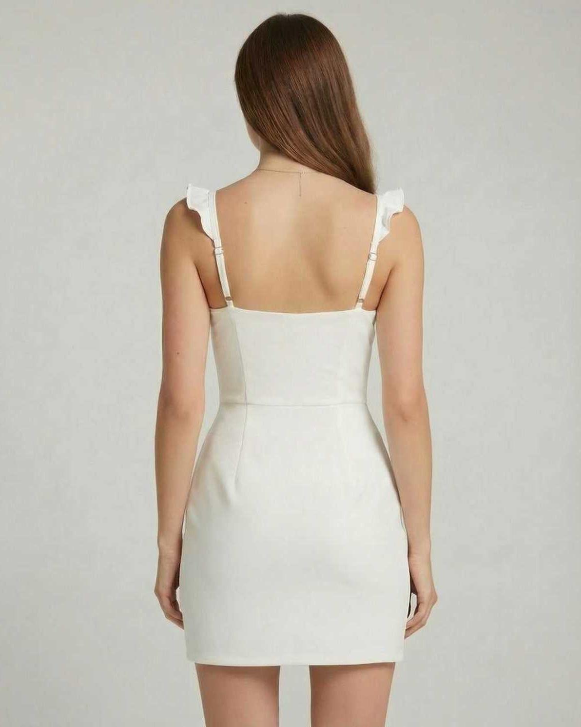 Elara Mini Dress - Back view showcasing ruffle trim and fitted design by Lauven in a clean white finish.