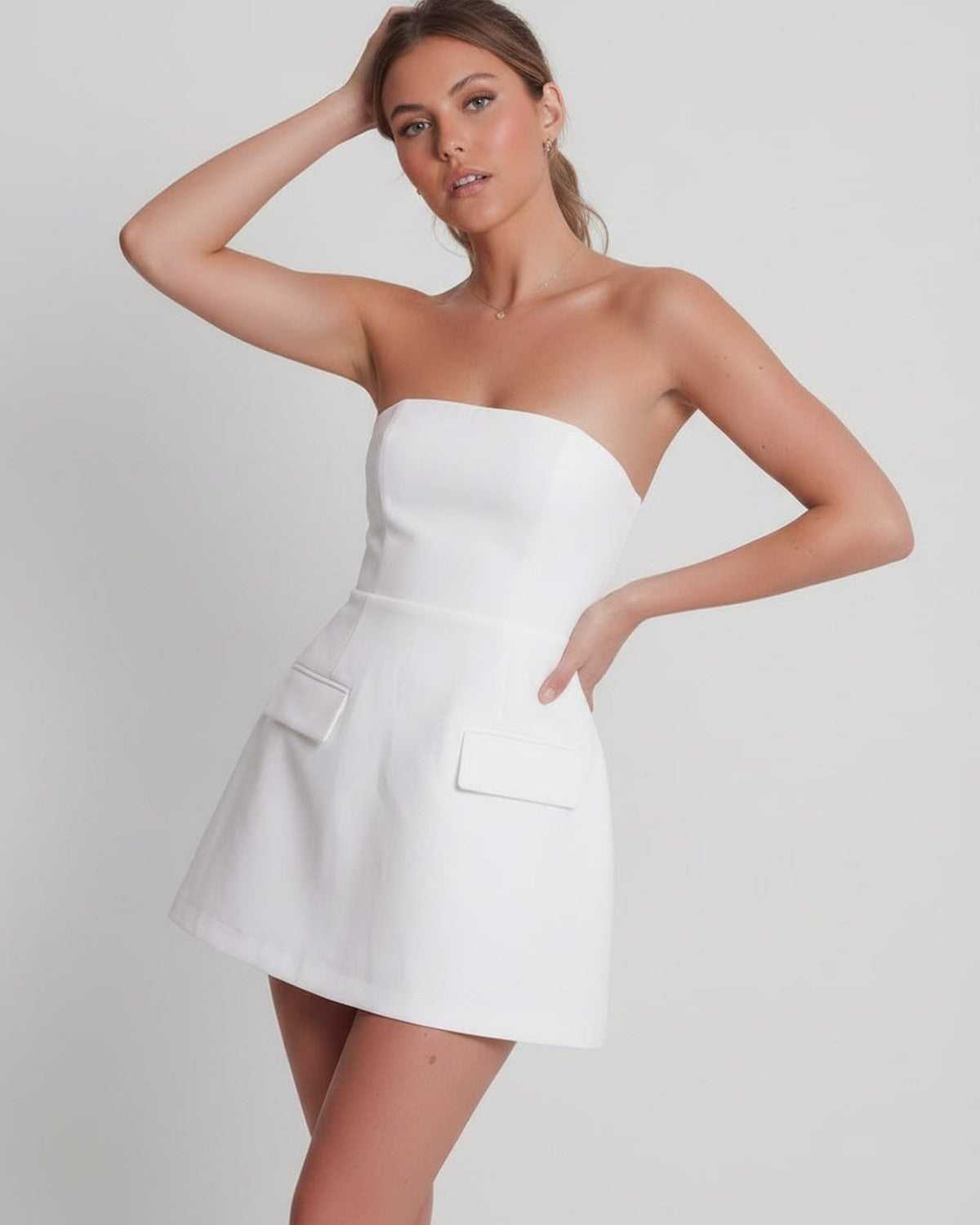 Elara Mini Dress on model, white strapless design, structured A-line silhouette by Lauven, perfect for modern elevated occasions.