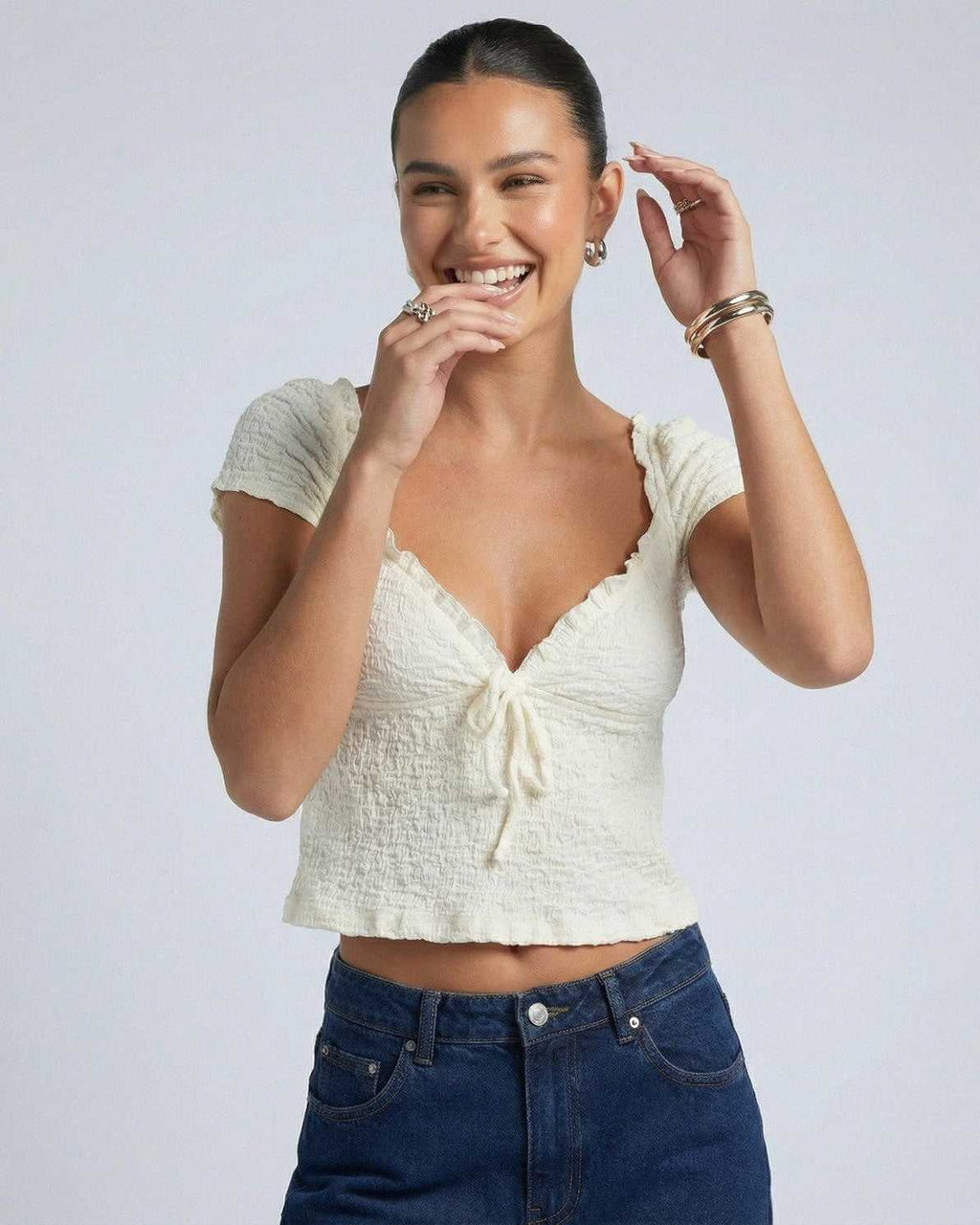Elara Tie Top by Lauven, a stylish ruched V-neck crop blouse with adjustable tie detail.