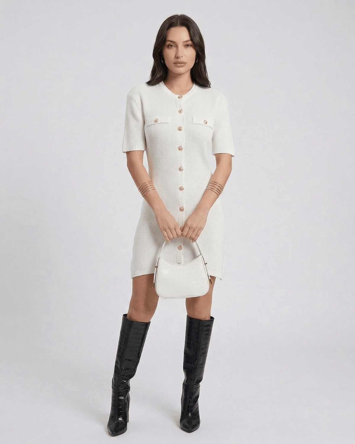 Elysia Mini Dress by Lauven featuring a chic knit design and button closure, styled with knee-high boots and a handbag.
