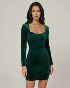 Emerald Mini Dress by Lauven featuring a luxurious green velvet bodycon design with long sleeves and square neckline.