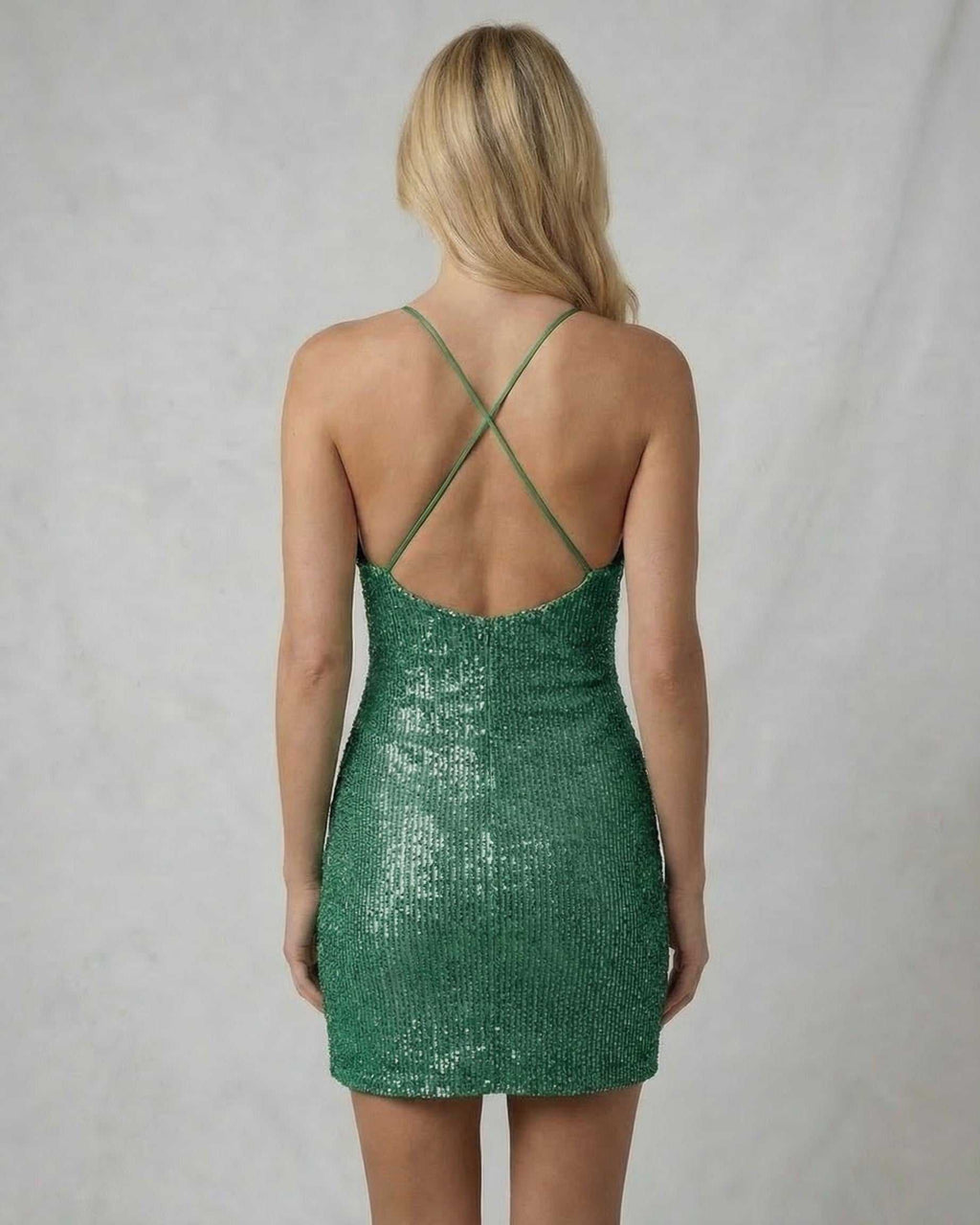 Emerald Mini Dress by Lauven, back view, showcasing luxurious sequin finish and crisscross spaghetti straps.