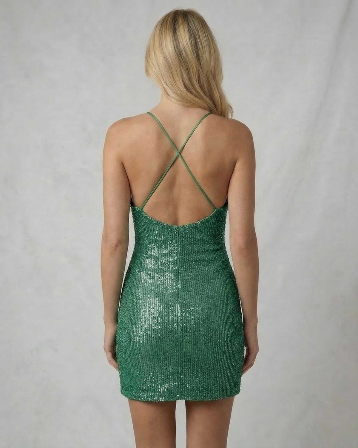Emerald Mini Dress by Lauven, back view, showcasing luxurious sequin finish and crisscross spaghetti straps.