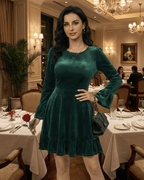 Emeraldia Mini Dress by Lauven worn in deep green velvet with long butterfly sleeves and A-line silhouette.