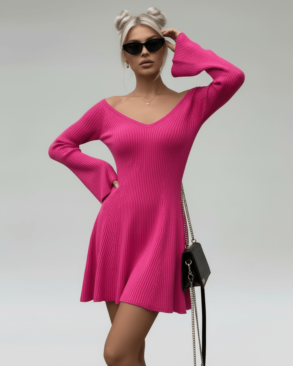 Model wearing Fiora Mini Dress by Lauven, a slim fit pink knit dress with V-neck and flared sleeves.