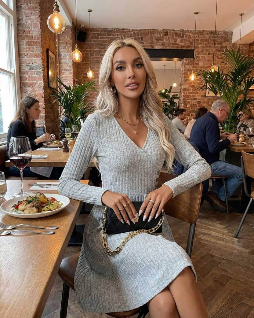 Florence Midi Dress by Lauven worn by a woman in a grey ribbed knit at a restaurant, showcasing elegance and sophistication.