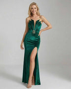Elegant model wearing the Celeste Maxi Dress by Lauven in emerald green velvet with a high slit.