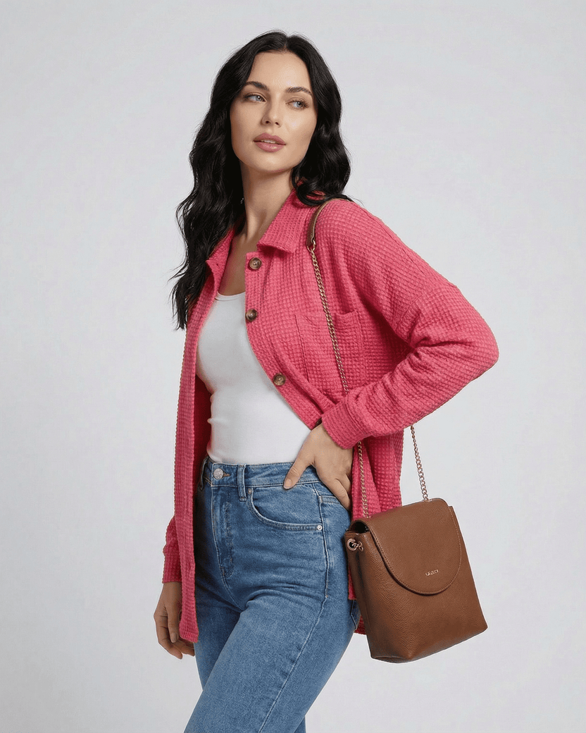 Women wearing the Verona Jacket by Lauven in pink waffle knit, styled with casual jeans and a brown handbag.