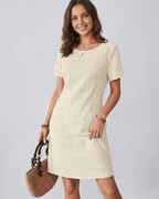 Avelin Mini Dress in textured fabric with round neckline, short sleeves, and stylish pockets by Lauven.